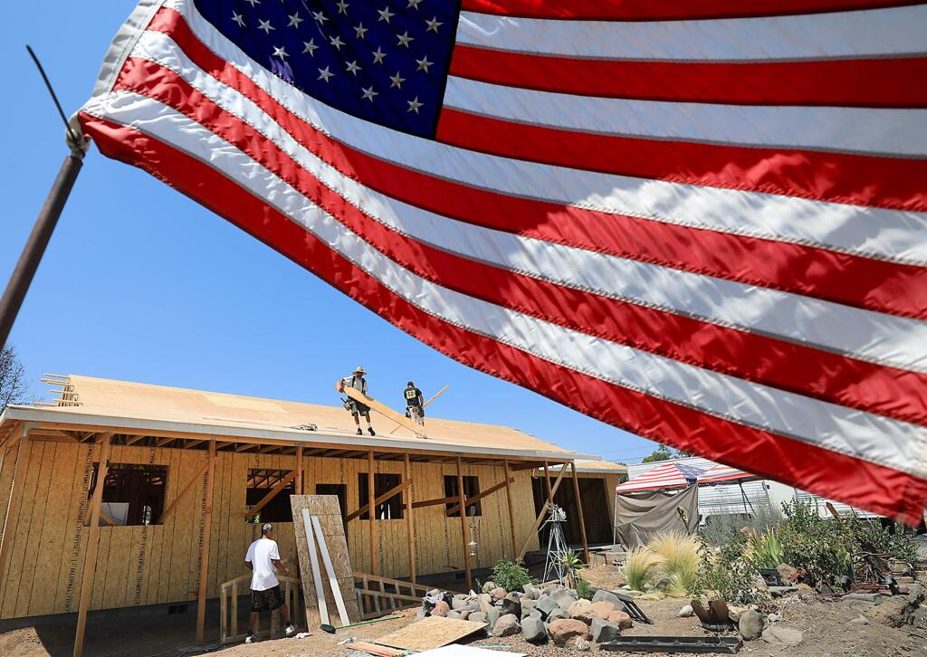 The home of Darron Redden is being rebuilt in Lower Lake, by Danny Lynch Construction, Tuesday August 8, 2017. Redden put the flag up shortly after the Clayton fire burned nearly half the town last August. (Kent Porter / The Press Democrat) 2017