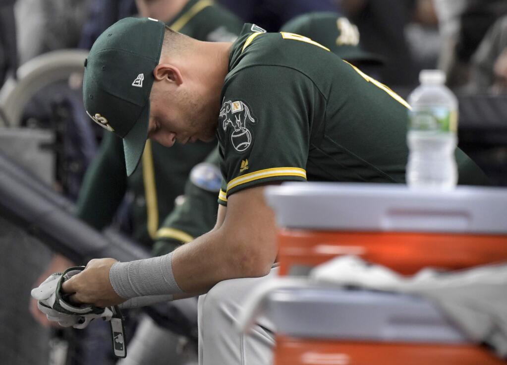 Oakland Athletics' Chad Pinder sits on the bench after the A's lost to the New York Yankees 7-2 in the American League wild-card playoff baseball game, Wednesday, Oct. 3, 2018, in New York. (AP Photo/Bill Kostroun)