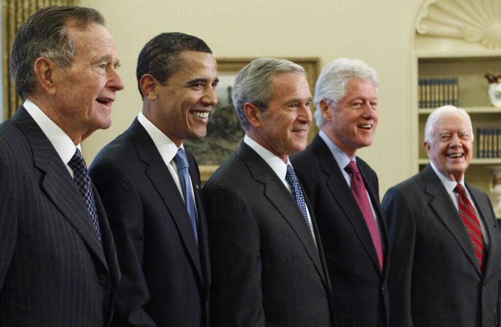 FILE - In this Jan. 7, 2009, file photo, President George W. Bush, center, poses with President-elect Barack Obama, second left, and former presidents, George H.W. Bush, left, Bill Clinton, second right, and Jimmy Carter, right, in the Oval Office of the White House in Washington. Bush has died at age 94. Family spokesman Jim McGrath says Bush died shortly after 10 p.m. Friday, Nov. 30, 2018, about eight months after the death of his wife, Barbara Bush. (AP Photo/J. Scott Applewhite, File)