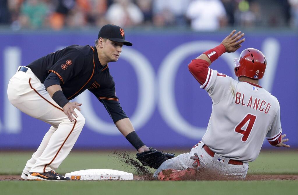 Philadelphia Phillies' Andres Blanco (4) is tagged out at second base by San Francisco Giants second baseman Joe Panik on a steal attempt during the second inning Saturday, June 25, 2016, in San Francisco. (AP Photo/Marcio Jose Sanchez)