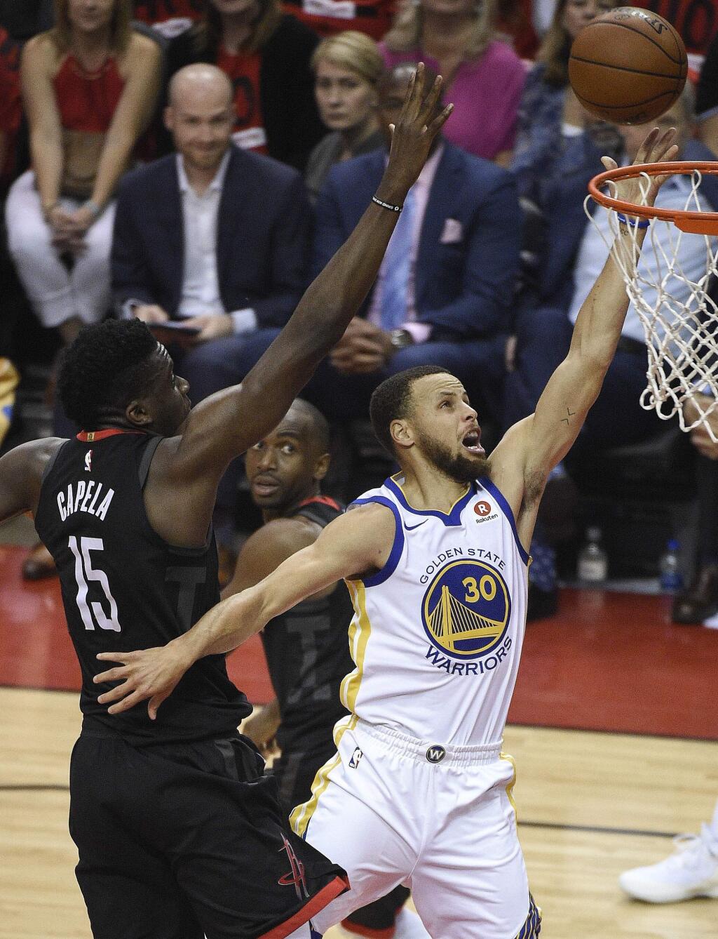 Golden State Warriors guard Stephen Curry (30) drives to the basket as Houston Rockets center Clint Capela (15) defends during the first half of Game 2 of the NBA basketball playoffs Western Conference finals Wednesday, May 16, 2018, in Houston. (AP Photo/Eric Christian Smith)