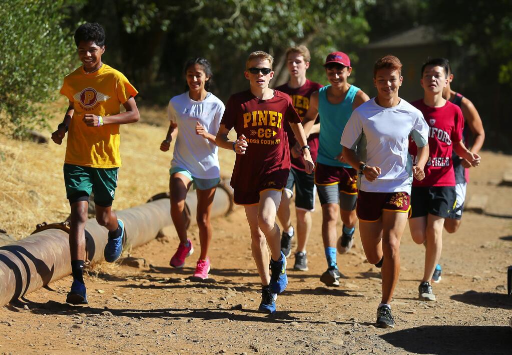 Piner cross country runners Jonny Vargas, left, Cynthia Rosales, Nathan Hayes, Ben Somma, Kevin Garcia, Ryan Ball and Austin Luong head out on a practice run at Howarth Park in Santa Rosa, on Thursday, June 23, 2016. (Christopher Chung / The Press Democrat)