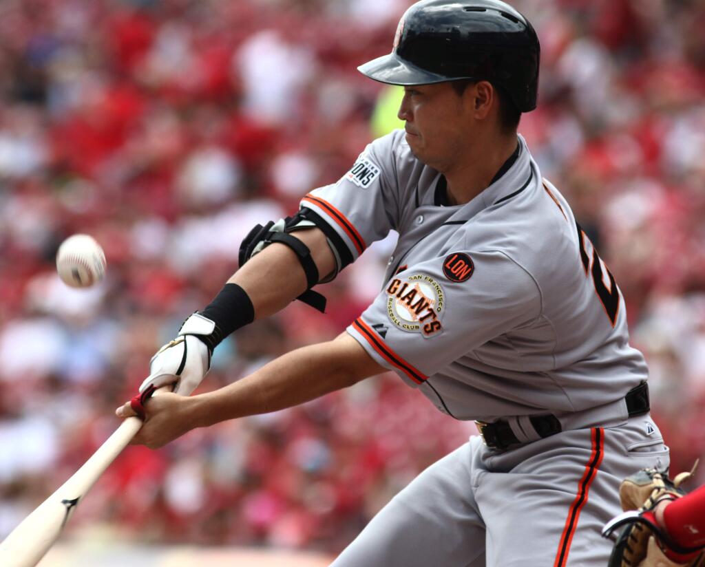 San Francisco Giants' Nori Aoki hits a foul ball against the Cincinnati Reds in the first inning of a baseball game in Cincinnati, Sunday, May 17, 2015. (AP Photo/Tom Uhlman)