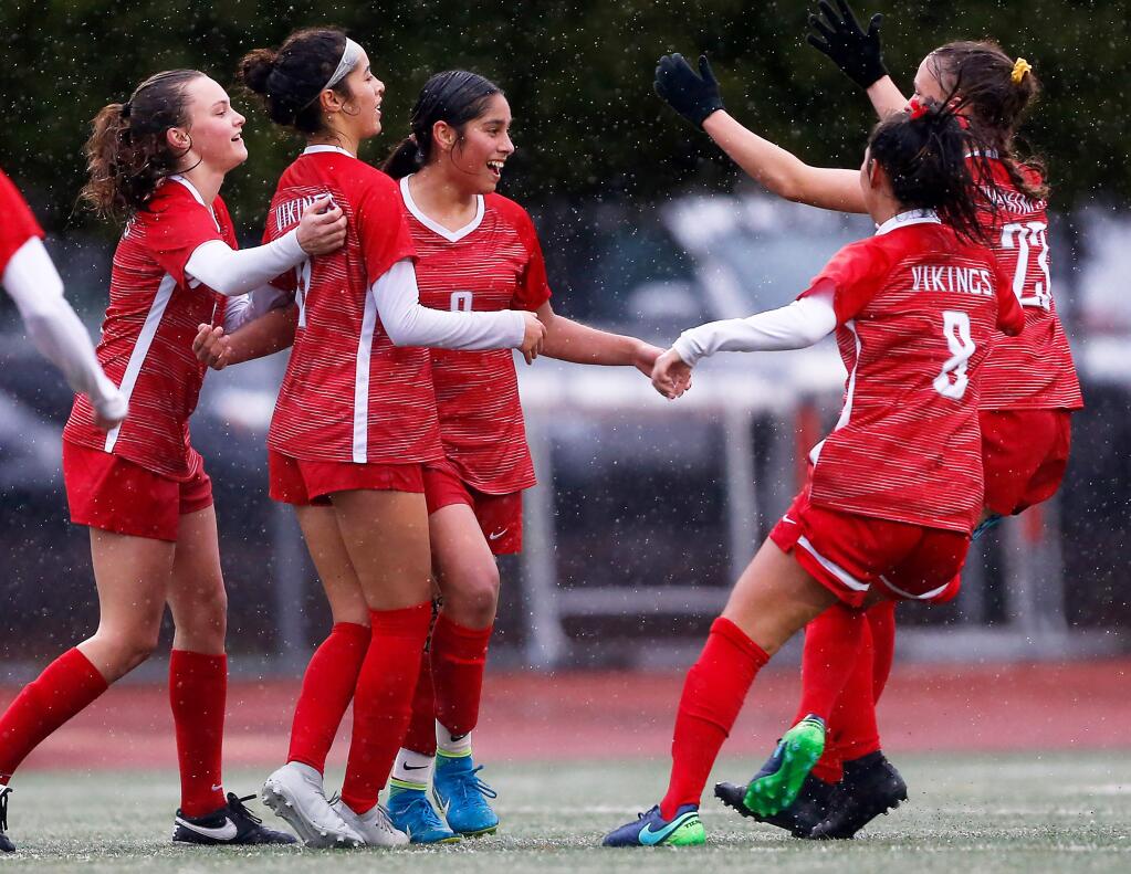 Montgomery's Angelica Barragan (9), center, celebrates with teammates Kaila Watkin (5), left, Kathy Monroy (11), Micky Rosenbaum (8), and Abria Brooker (23) after she scored the Vikings' first goal during the first half of the CIF NorCal regional girls varsity soccer tournament game between Menlo and Montgomery high schools, in Santa Rosa on Tuesday, February 26, 2019. (Alvin Jornada / The Press Democrat)