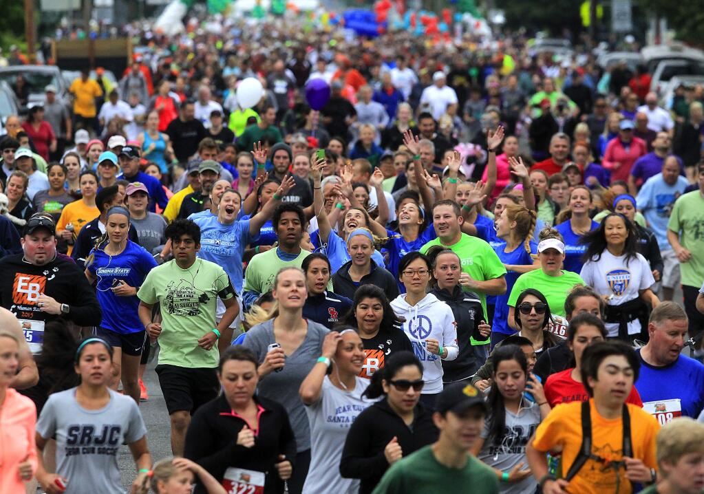 Thousands of runners and walkers head down Sonoma Ave. for the start of the Human Race in Santa Rosa on Saturday morning. (JOHN BURGESS / The Press Democrat)