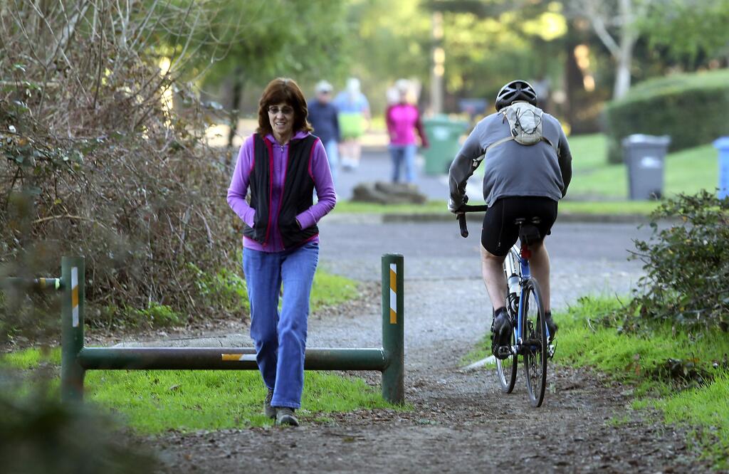 A biker heads out of Annadel State Park to Timber Springs Drive in the Wild Oak subdivision near Oakmont. The road in part of a pedestrian easement to the park which the homeowners association claims does not allow for bicycles on the path or road. (Photo by John Burgess/The Press Democrat)