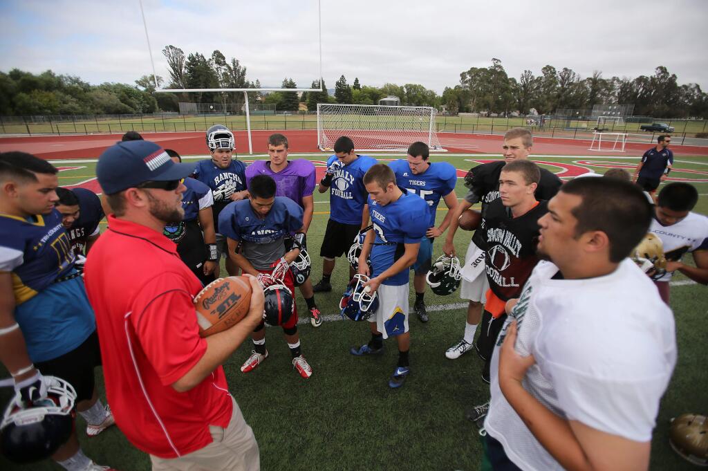 Gehrig Hotaling, head coach of the South football team for the Kiwanis All-Star football game, talks to the team during practice at Rancho Cotate High School, Wednesday, July 16, 2014. (Crista Jeremiason / The Press Democrat)