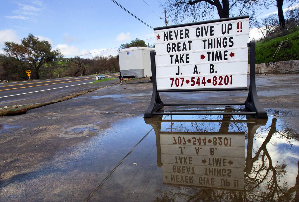 John Thill lost both his Coffey Park home and his business, John's Auto Body, in the October fires. His sign on Mark West Springs Rd. has made a return on the site of his old shop. (Photo by John Burgess/The Press Democrat)