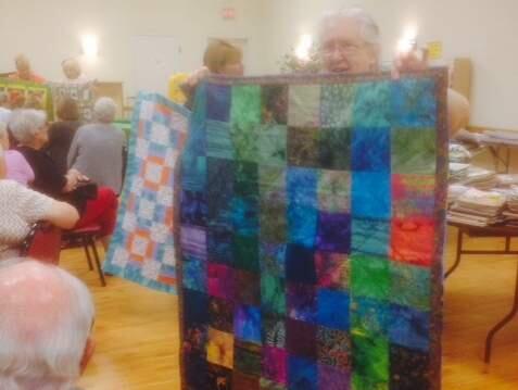 Mirna Estes, a member of the Santa Rosa Quilt Guild, shows off one of the donations to the Valley of the Moon Children's Home on Thursday, April 2, 2015. (CHRIS SMITH/ PD)
