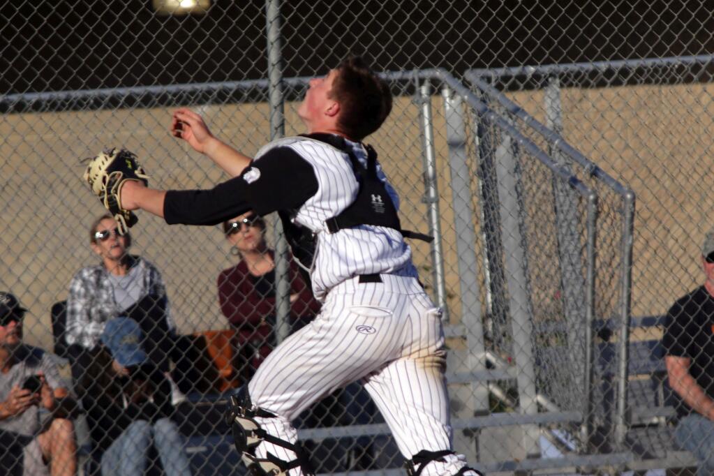 DWIGHT SUGIOKA/FOR THE ARGUS-COURIERPetaluma catcher Jack Gallagher takes off after a foul pop-up. Gallagher made the catch and Petaluma beat Piner, 10-1.