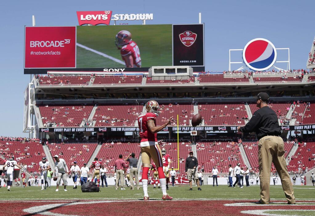 Colin Kaepernick (7) catches the ball from Jim Harbaugh before Sunday's preseason home opener against the Broncos. (Associated Press / Marcio Jose Sanchez)