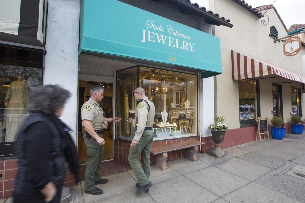 Sonoma police officers compare notes on the scene of an armed robbery, reported on Thursday afternoon, March 1, at Studio Jewelry in Sonoma. (Robbi Pengelly/Index-Tribune)