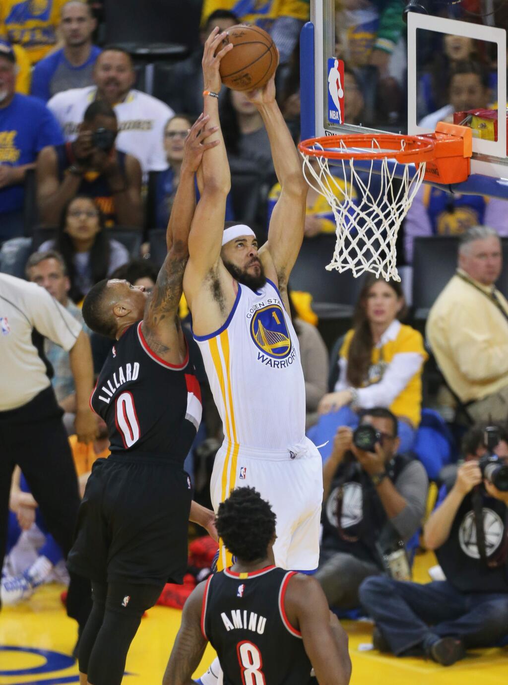 Golden State Warriors center JaVale McGee throws down a dunk over Portland Trailblazers guard Damian Lillard during Game 2 of the first round of NBA playoffs in Oakland on Wednesday, April 19, 2017. (Christopher Chung/ The Press Democrat)