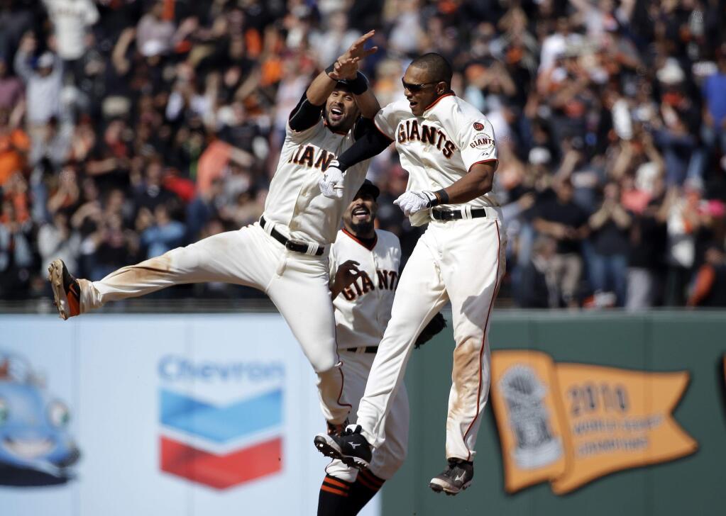 San Francisco Giants' Justin Maxwell, right, celebrates with teammates Sergio Romo, center, and Angel Pagan after Maxwell drove in the game-winning run with a single against the Los Angeles Dodgers during the 10th inning of a game on Thursday, April 23, 2015, in San Francisco. San Francisco won 3-2. (AP Photo/Marcio Jose Sanchez)
