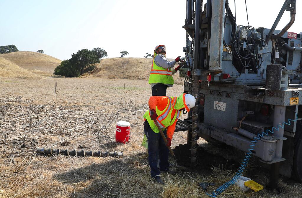 Tony Valencia, foreground, and Eddie Velasquez, of Technicon Engineering Services, Inc., collect soil samples from the area where Sonoma Clean Power's first solar power project will be installed, at the Lavio ranch property, near Petaluma on Thursday, August 31, 2017. (Christopher Chung/ The Press Democrat)