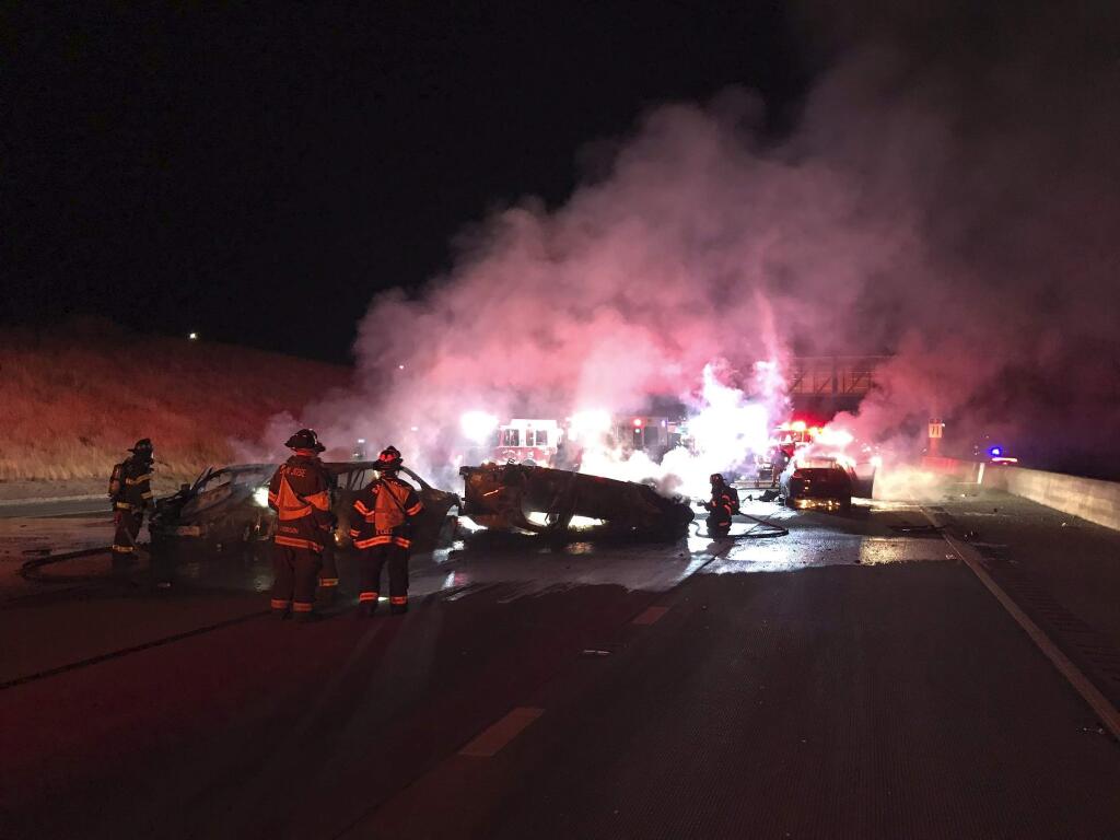 In this Thursday, Aug. 8, 2019, photo released by the San Jose Fire Department shows a fiery four-vehicle crash in San Jose, Calif. The California Highway Patrol says one person died and two others were injured in the accident on Highway 101 in San Jose that caused traffic to back up for miles. San Jose Fire Captain Brad Cloutier says all four vehicles caught fire and were destroyed in the collision north of Bailey Avenue and south of state Highway 85. (San Jose Fire Department via AP)