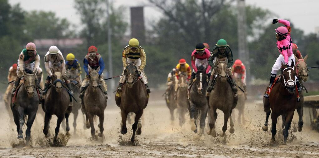 Luis Saez riding Maximum Security, right, crosses the finish line first ahead of Country House, center, and jockey Flavien Prat, during the 145th running of the Kentucky Derby horse race at Churchill Downs Saturday, May 4, 2019, in Louisville, Ky. Country House was declared the winner after Maximum Security was disqualified following a review by race stewards. (AP Photo/Darron Cummings)
