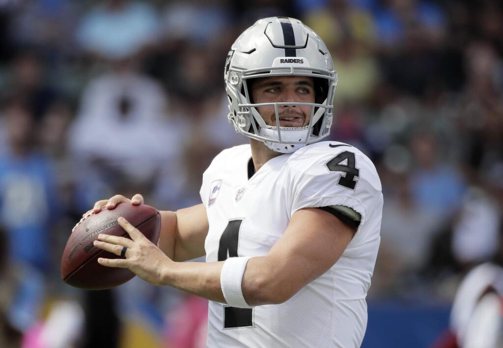 Oakland Raiders quarterback Derek Carr prepares to throw a pass during the first half of an NFL football game against the Los Angeles Chargers, Sunday, Oct. 7, 2018, in Carson, Calif. (AP Photo/Jae C. Hong)