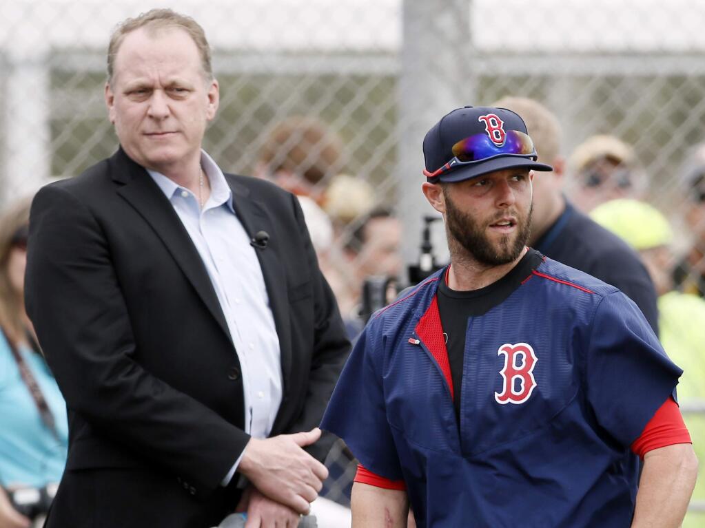 Baseball analyst and former Boston Red Sox pitcher Curt Schilling, left, watches as Dustin Pedroia, right, and other infielders take batting practice at baseball spring training in Fort Myers Fla., Wednesday Feb. 25, 2015. (AP Photo/Tony Gutierrez)
