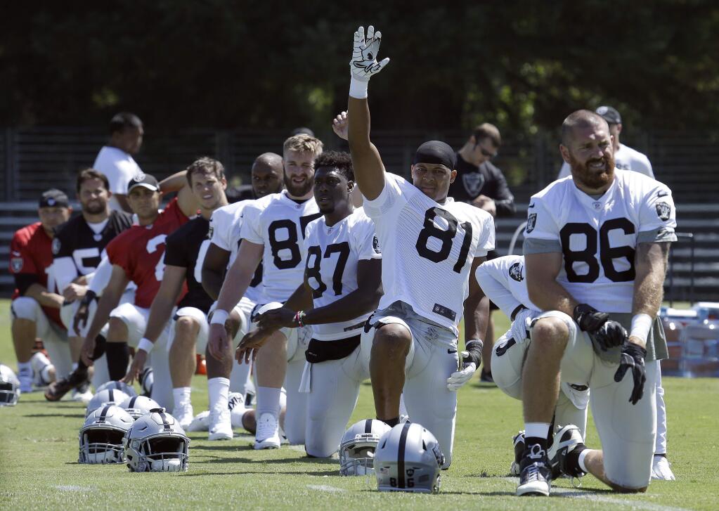 Oakland Raiders including Pharaoh Brown (81) and Lee Smith (86) stretch during an training camp on Saturday, July 29, 2017, in Napa. (AP Photo/Ben Margot)