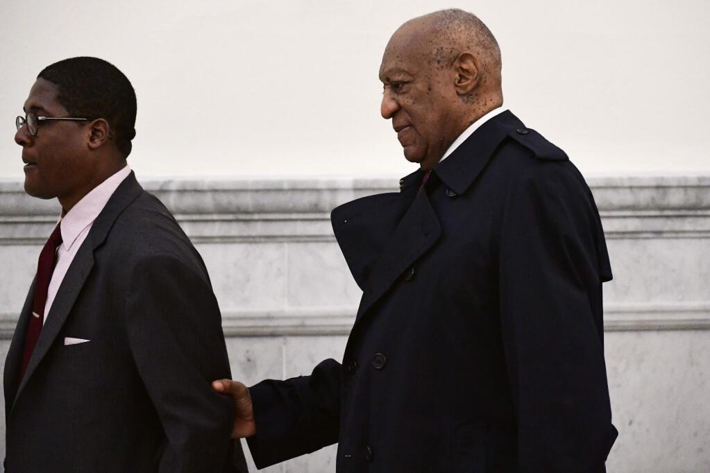 Bill Cosby, right, is led by spokesperson Andrew Wyatt at the Montgomery County Courthouse for Cosby's sexual assault trial, Wednesday, April 25, 2018, in Norristown, Pa. (AP Photo/Corey Perrine, Pool)