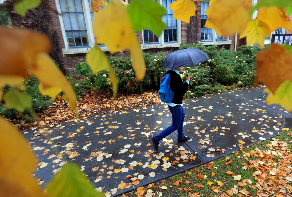An SRJC student walks from class as the first in the series of much needed rain coats Sonoma County, Wednesday Nov. 19, 2014 in Santa Rosa. (Kent Porter / Press Democrat) 2014