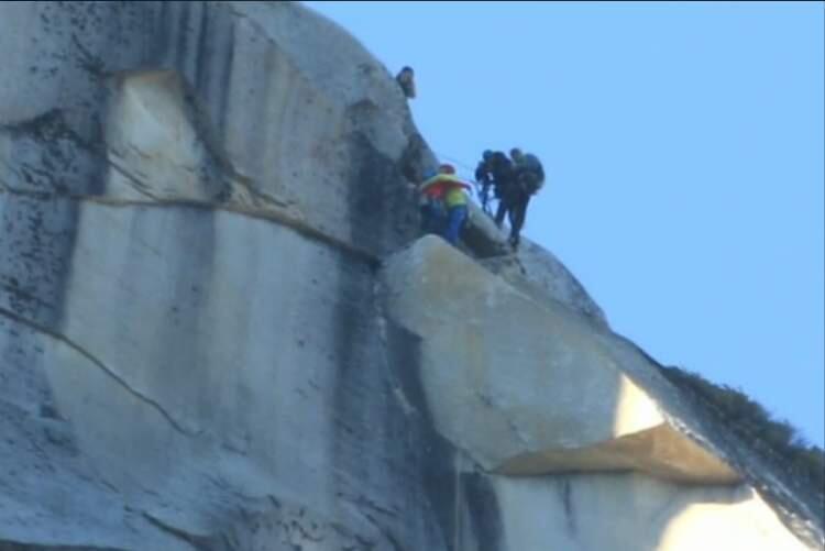 After a grueling 19 days, Kevin Jorgeson and Tommy Caldwell embrace at the top of El Capitan. (photo via NBC Live Stream)