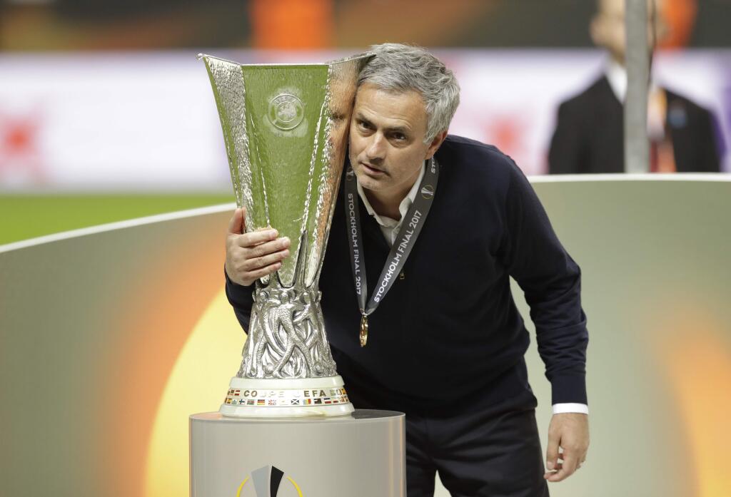 Manchester United manager Jose Mourinho poses with the trophy after winning the Europa League final between Ajax Amsterdam and Manchester United at the Friends Arena in Stockholm, Sweden, Wednesday, May 24, 2017. (AP Photo/Michael Sohn)