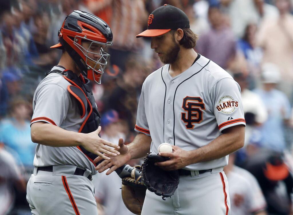 San Francisco Giants catcher Andrew Susac, left, congratulates starting pitcher Madison Bumgarner after Bumgarner threw a 9-0, complete-game shutout against the New York Mets in a baseball game in New York, Sunday, Aug. 3, 2014. (AP Photo/Kathy Willens)
