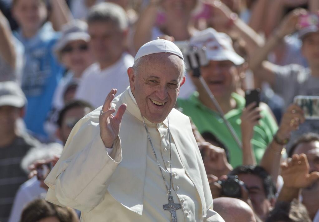Pope Francis waves as arrives for his weekly general audience in St. Peter's Square at the Vatican, Wednesday, Aug. 26, 2015. (AP Photo/Alessandra Tarantino, File)