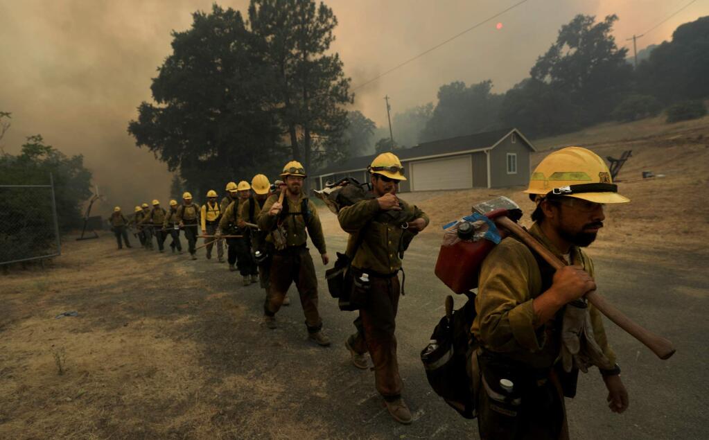 At the Upper Lake Rancheria, a crew of Mendocino National Forest hotshots band up to protect structures as the Ranch fire rolls in to the outskirts of Upper Lake on Monday, July 30, 2018. (KENT PORTER/ PD)