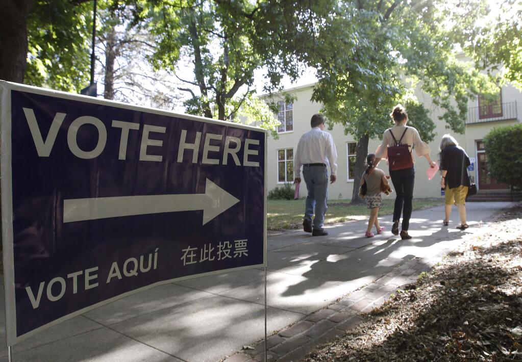 Voters walk to a precinct place at the Sierra 2 Center for the Arts and Community to cast their ballots Tuesday, June 5, 2018, in Sacramento, Calif. Voters are casting ballots in California's primary election, setting the stage for November races. (AP Photo/Rich Pedroncelli)