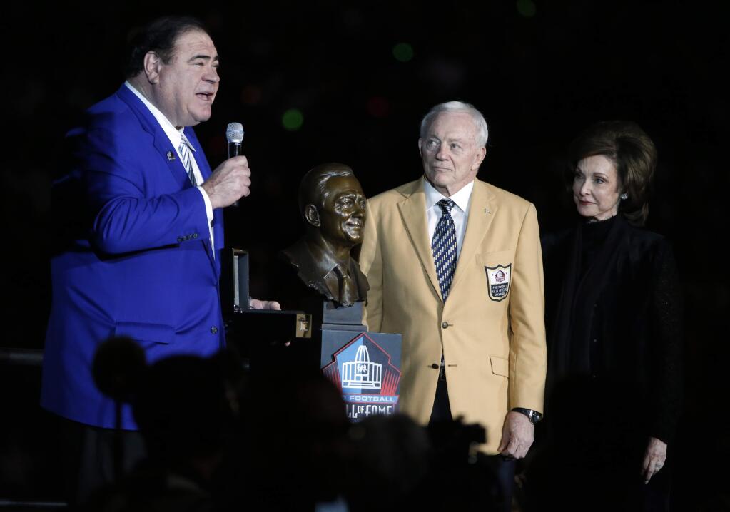 David Baker, president an CEO of the Hall of Fame presents Dallas Cowboys team owner Jerry Jones, center, who stands with his wife Gene, right, his HOF ring at halftime of a game against the Philadelphia Eagles on Sunday, Nov. 19, 2017, in Arlington, Texas. (AP Photo/Michael Ainsworth)