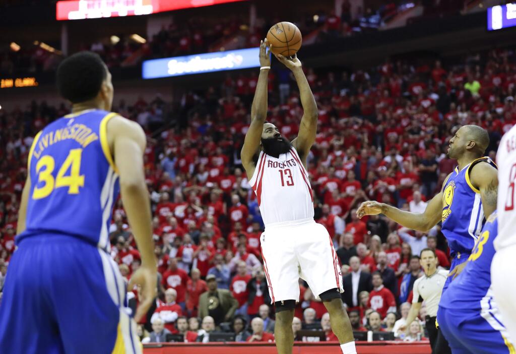 Houston Rockets guard James Harden scores the winning basket during the second half in Game 3 of a first-round NBA basketball playoff series against the Golden State Warriors, Thursday, April 21, 2016, in Houston. (AP Photo/David J. Phillip)