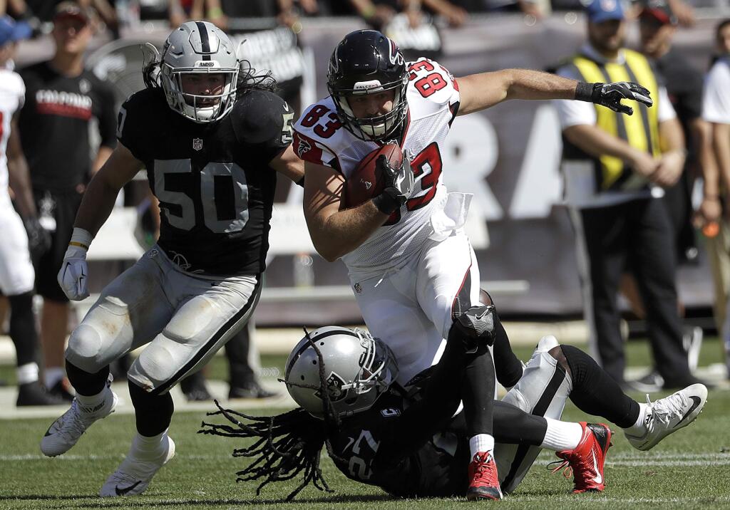 Atlanta Falcons tight end Jacob Tamme (83) runs against Oakland Raiders middle linebacker Ben Heeney (50) and free safety Reggie Nelson during the first half of an NFL football game in Oakland, Calif., Sunday, Sept. 18, 2016. (AP Photo/Marcio Jose Sanchez)