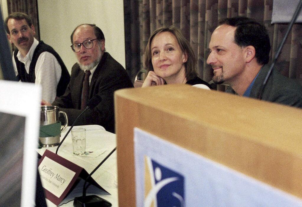 File - In this April 15, 1999 file photo, Geoffrey Marcy, right, then a professor at San Francisco State University, sits with Tim Brown, a senior scientist for the National Center for Atmospheric Research, from left, Robert Noyes, a professor at the Harvard-Smithsonian Center for Astrophysics, and Debra Fischer, a post-doctoral researcher at SFSU, at a news conference in San Francisco. The University of California, Berkeley is defending its handling of sexual harassment complaints against Marcy, a prominent astronomer, amid accusations that the professor was inadequately disciplined for inappropriate behavior with students. (AP Photo/Randi Lynn Beach, file)