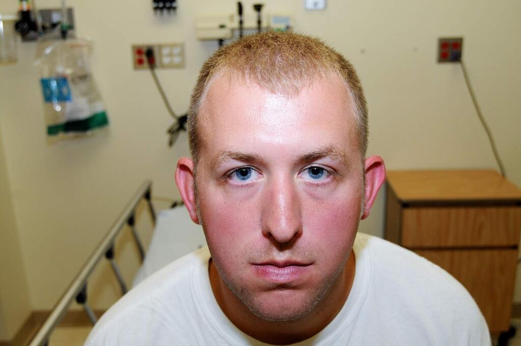 FILE - This 2014 file photo provided by the St. Louis County Prosecuting Attorney's office is Ferguson police officer Darren Wilson during his medical examination after he fatally shot Michael Brown, in Ferguson, Mo.  (AP Photo/St. Louis County Prosecuting Attorney's Office, File)