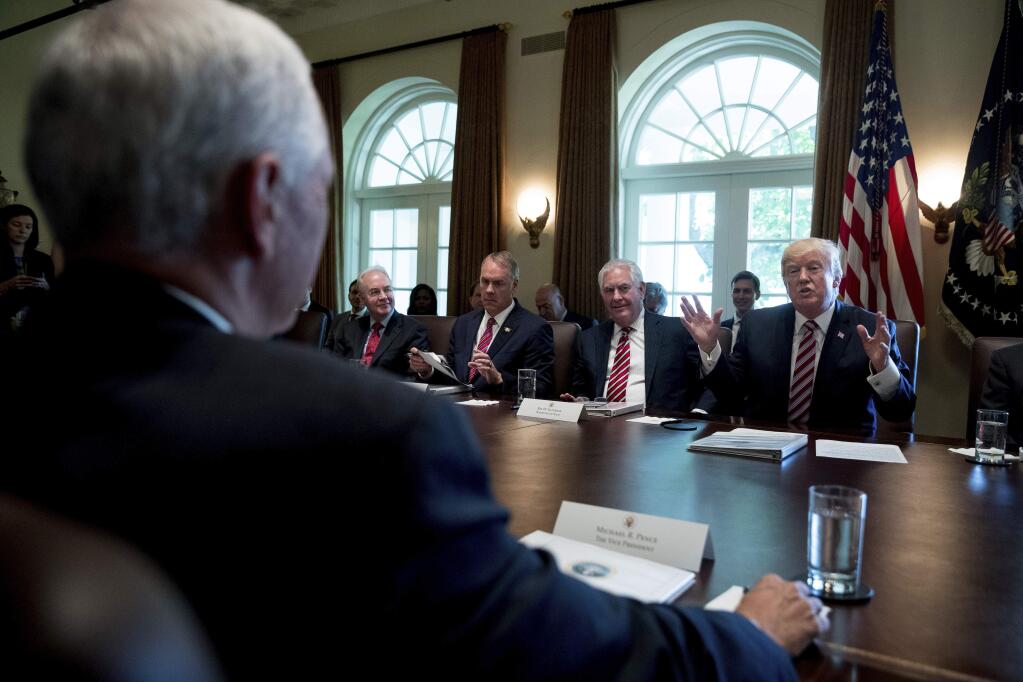 President Donald Trump speaks during a Cabinet Meet, Monday, June 12, 2017, in the Cabinet Room of the White House in Washington. From left are, Vice President Mike Pence, foreground, Health and Human Services Secretary Tom Price, Interior Secretary Ryan Zinke and Secretary of State Rex Tillerson and the president . (AP Photo/Andrew Harnik)