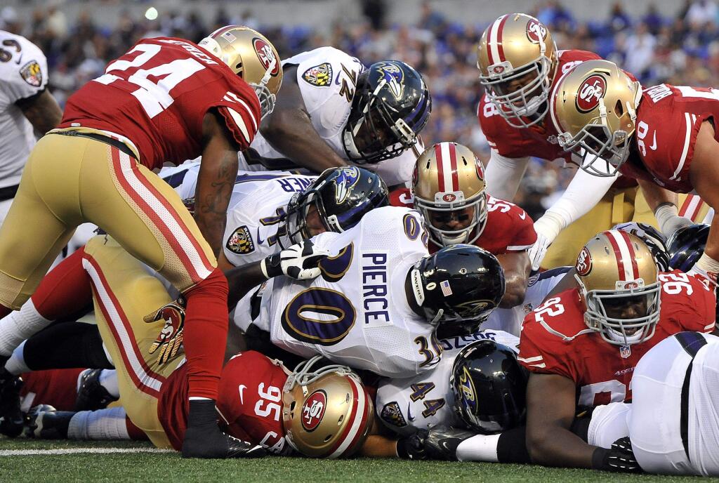 Baltimore Ravens running back Bernard Pierce (30) falls into the end zone for a touchdown in the first half of an NFL preseason football game against the San Francisco 49ers, Thursday, Aug. 7, 2014, in Baltimore. (AP Photo/Gail Burton)