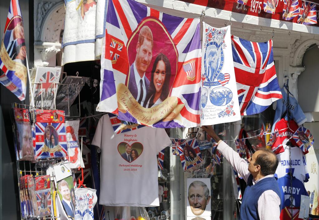 A man looks at a souvenir shop in Windsor, Tuesday, May 15, 2018. Preparations are being made in the town ahead of the wedding of Britain's Prince Harry and Meghan Markle that will take place in Windsor on Saturday May 19.(AP Photo/Frank Augstein)