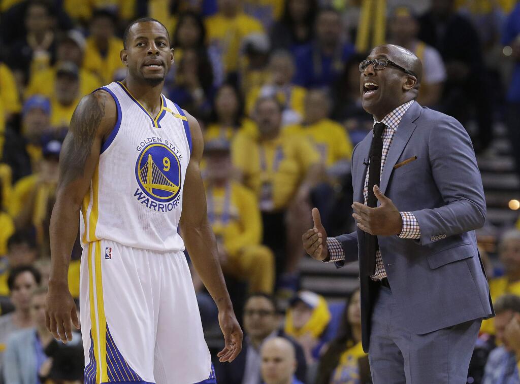 Golden State Warriors interim head coach Mike Brown, right, gestures next to forward Andre Iguodala (9) during the first half of Game 1 of the NBA basketball Western Conference finals against the San Antonio Spurs in Oakland, Calif., Sunday, May 14, 2017. (AP Photo/Jeff Chiu)