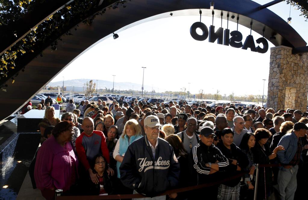 People wait outside before the grand opening of the Graton Resort & Casino in Rohnert Park on Nov. 5, 2013. Last month, the casino and resort celebrated its fifth anniversary. Within 200, how many people are employed at the Rohnert Park facility? (BETH SCHLANKER / The Press Democrat)