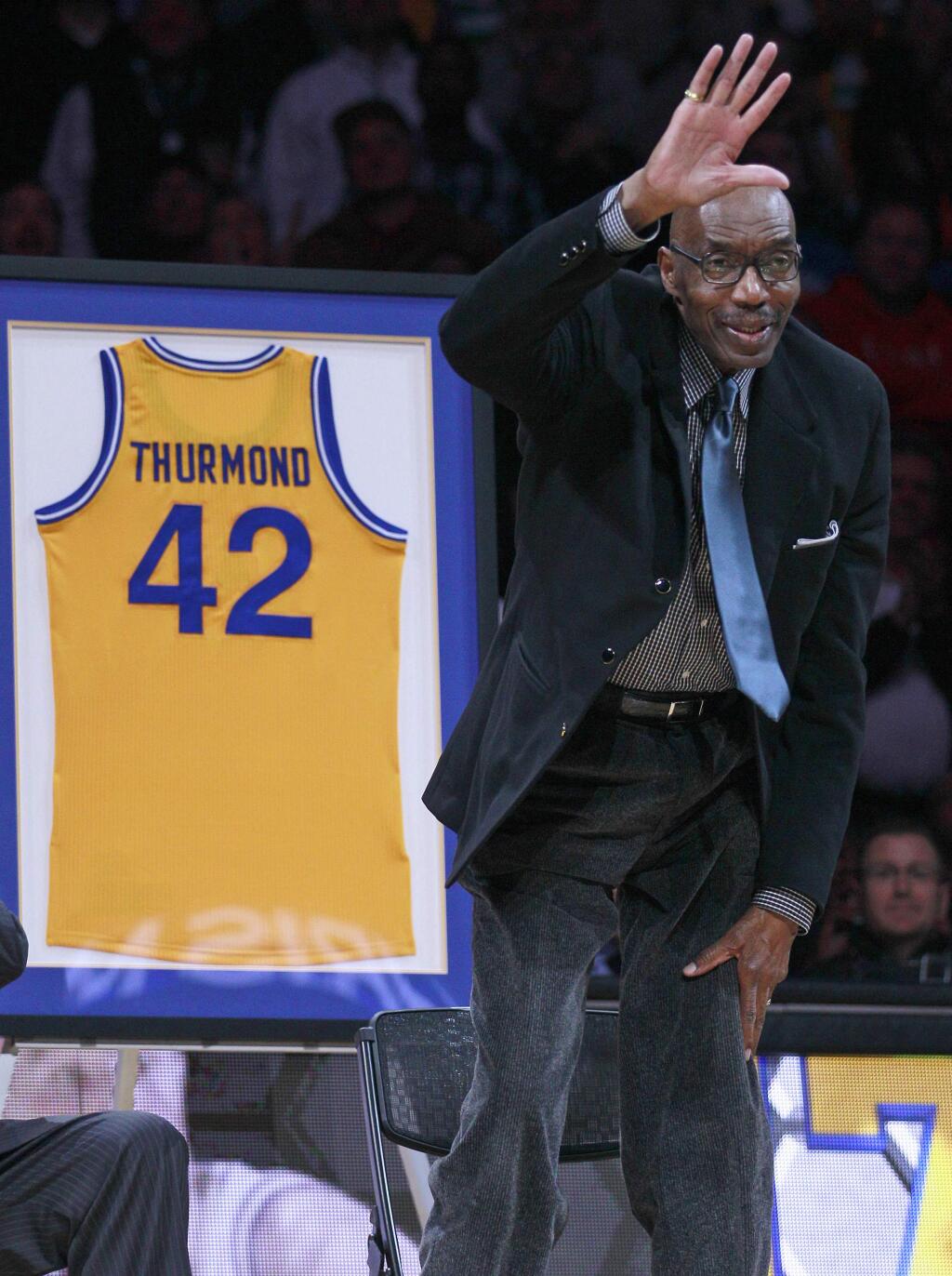 FILE - In this March 19, 2012, file photo, former Golden State Warriors player Nate Thurmond waves during a halftime ceremony if an NBA basketball game between the Warriors and the Minnesota Timberwolves in Oakland, Calif. Thurmond, a Hall of Fame center and longtime Golden State Warrior, died Saturday, July 16, 2016, after a short battle with leukemia, the team announced. He was 74. (AP Photo/Jeff Chiu, File)