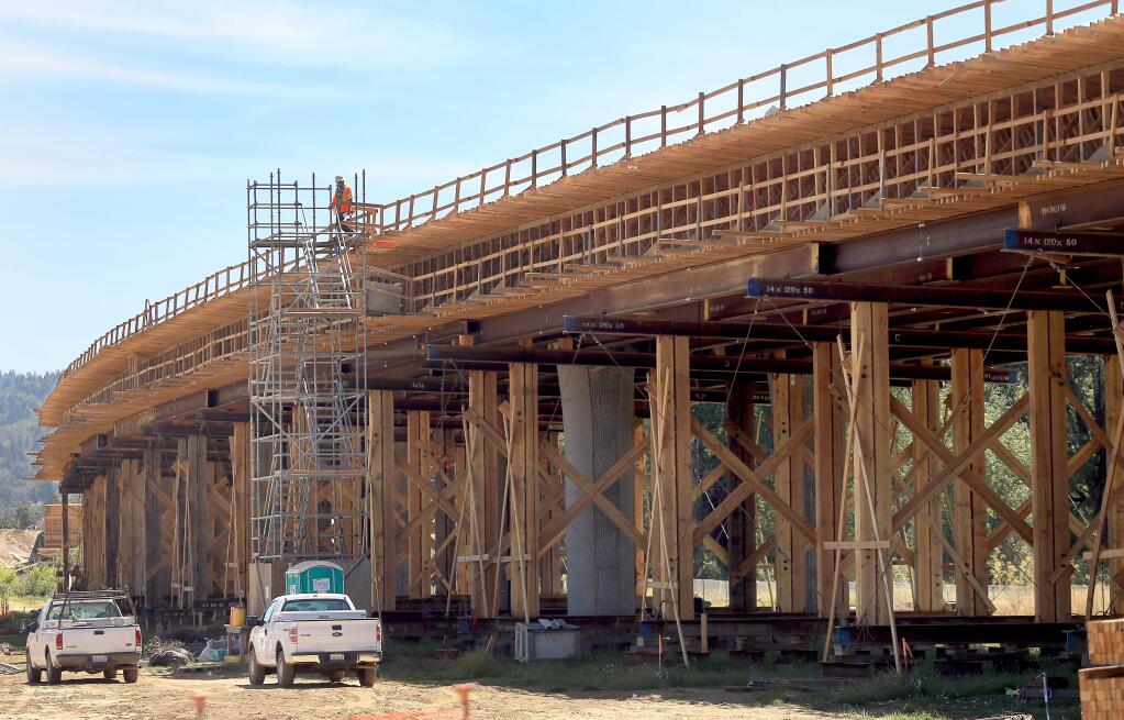 Workers construct the Willits bypass, Monday June 23, 2014. (KENT PORTER/ PD FILE)