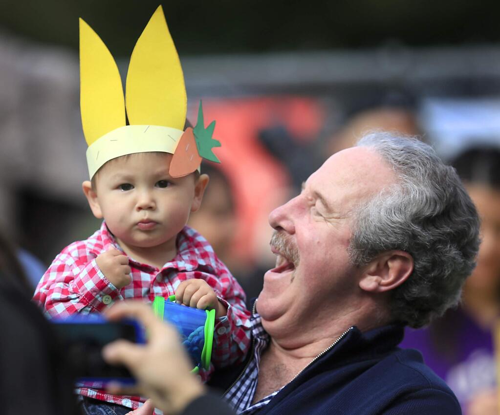 Tom Gannon of Dublin attempts to make his grandson William Gannon, 16 mos., laugh for a picture at Howarth Park in Santa Rosa, Saturday March 30, 2013 prior to the spring egg hunt. (Kent Porter / Press Democrat) 2013