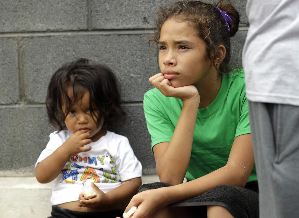 Angui Funes, right, sits with her brother, Jesus, after crossing the border back to Reynosa, Mexico, Thursday, June 21, 2018. The family, who was seeking asylum, said they were told by officials they would be separated so they voluntarily returned to Mexico. (AP Photo/David J. Phillip)