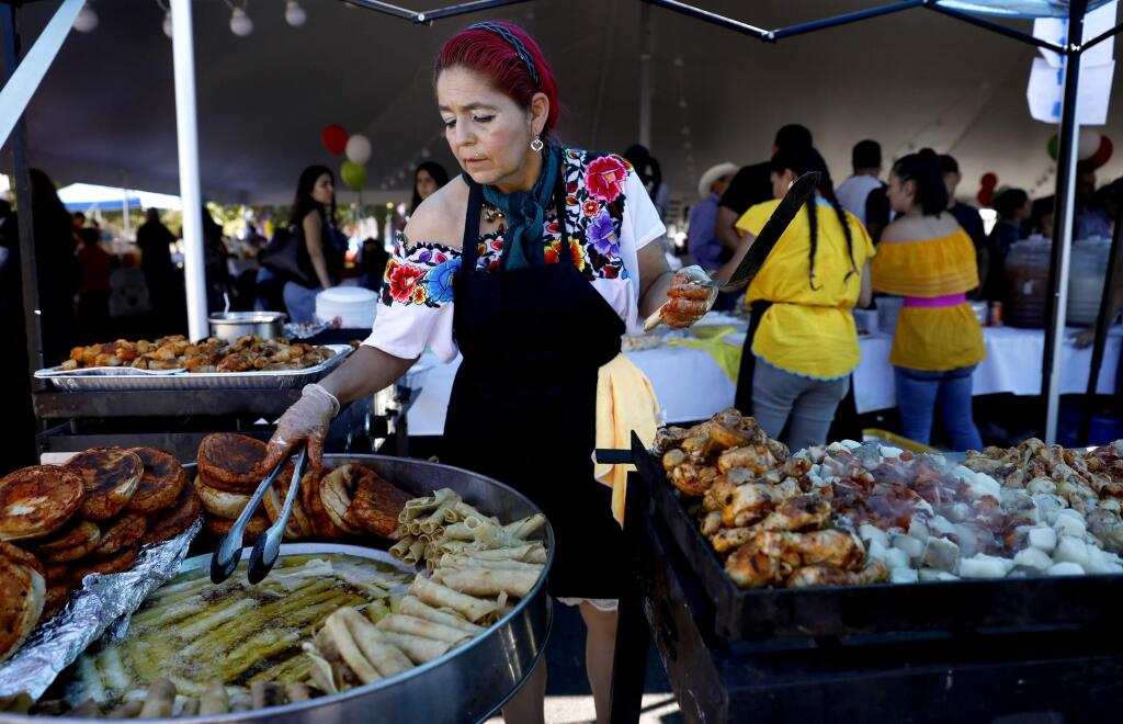 Olivia Estrada fries flautas during the Fiesta de Independencia at the Luther Burbank Center for the Arts in Santa Rosa on Sunday, September 16, 2018. (Beth Schlanker/ The Press Democrat)