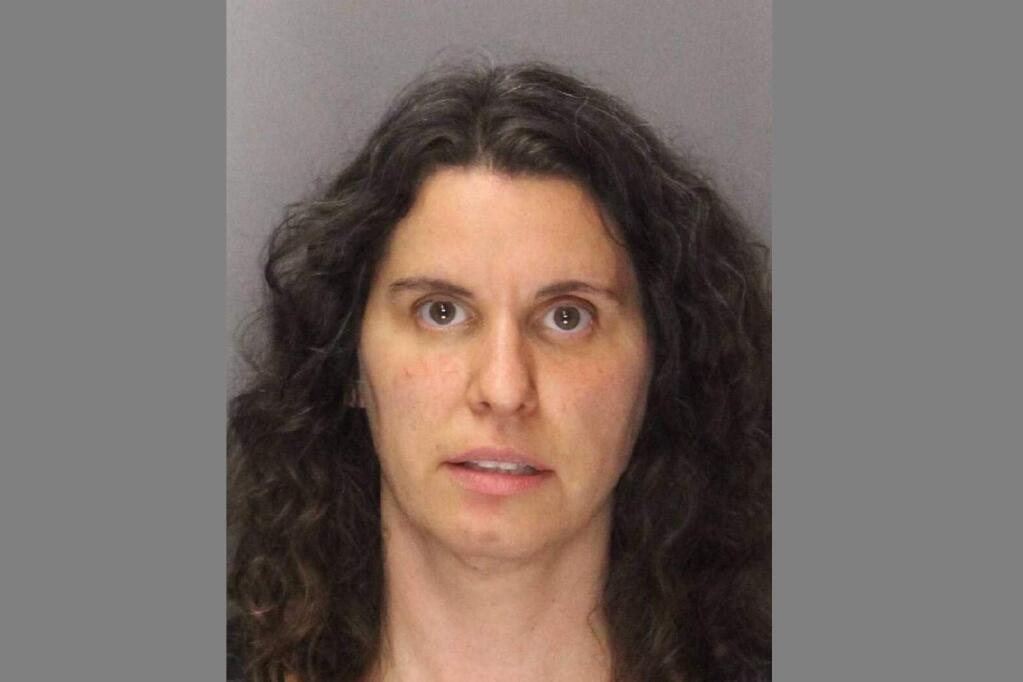 FILE - This Sept. 13, 2019, file photo booking photo shows Rebecca Dalelio, 43, who was arrested and jailed in the County Main Jail in Sacramento, Calif. California police have arrested Dalelio, who threw a feminine hygiene device containing 'what appeared to be blood' onto the floor of the state Senate on Friday, splashing onto lawmakers and forcing them to finish their work in a committee room on the final day of the legislative session. Test results have confirmed the red liquid thrown on the floor of the California Senate last month was human blood, but it did not contain pathogens or infections. The California Senate was delayed for several hours on the final day of the legislative session last month after a woman threw blood from the public gallery, some of which landed on several senators. Wednesday, Oct. 2, 2019, a letter from Secretary of the Senate Erika Contreras said the chamber is now open to the public. (Sacramento County Sheriff's Office via AP, File)