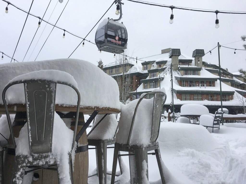 File - In this March 2, 2018, file photo provided by the Heavenly Mountain Resort, fresh snow covers most of a table and chairs in South Lake Tahoe, Calif. (Heavenly Mountain Resort via AP, File)