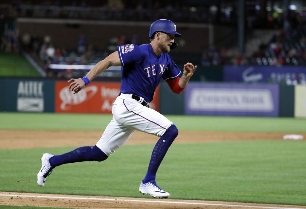 In this May 21, 2019, file photo, the Texas Rangers' Hunter Pence sprints home to score on a Nomar Mazara double in the sixth inning against the Seattle Mariners in Arlington, Texas. (AP Photo/Tony Gutierrez, File)